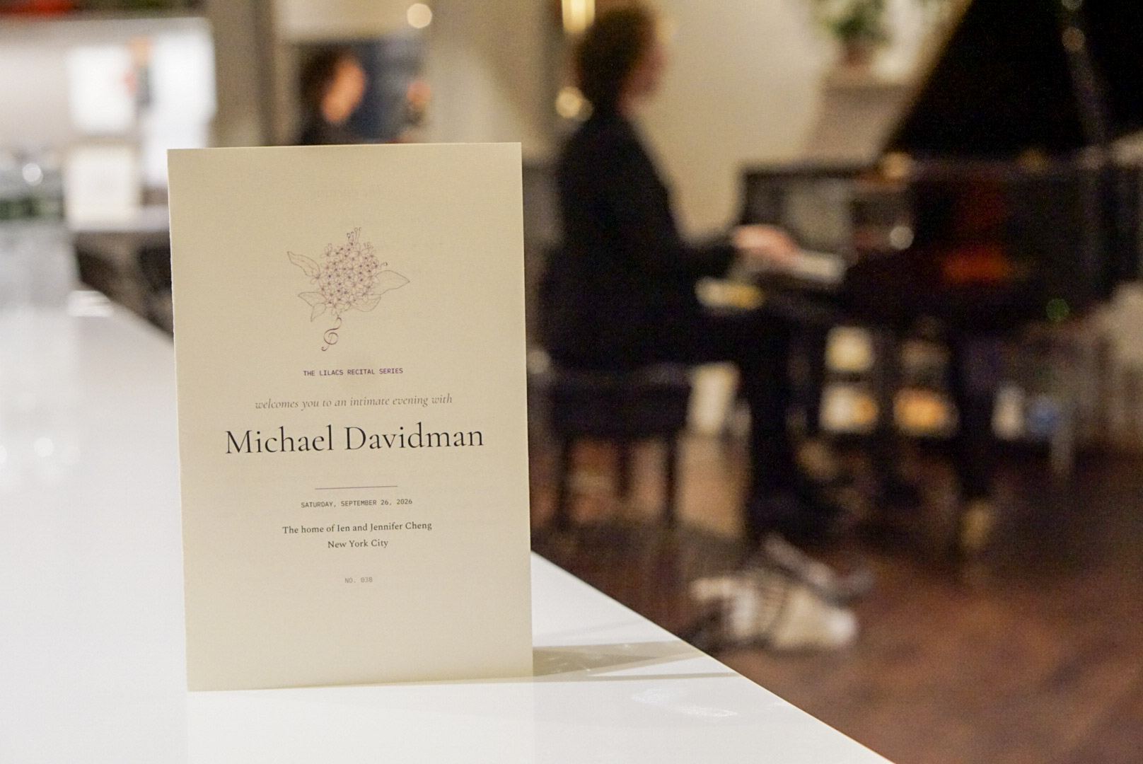 The program, on the counter, and the pianist behind